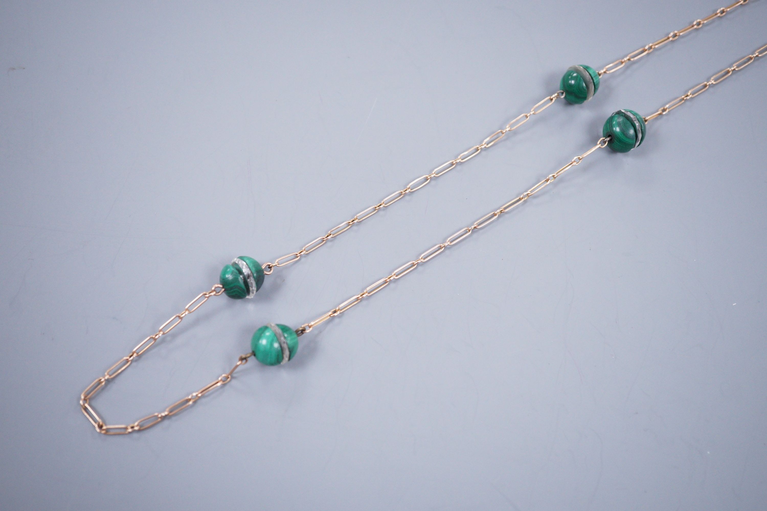A gold, malachite and glass chain necklace, 82cm (tests as 9ct), gross 24.3 grams